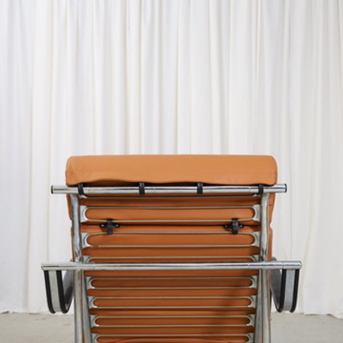 Rear detail of the cognac leather upholstery and chrome frame on a Yrjö Kukkapuro Remmi chair