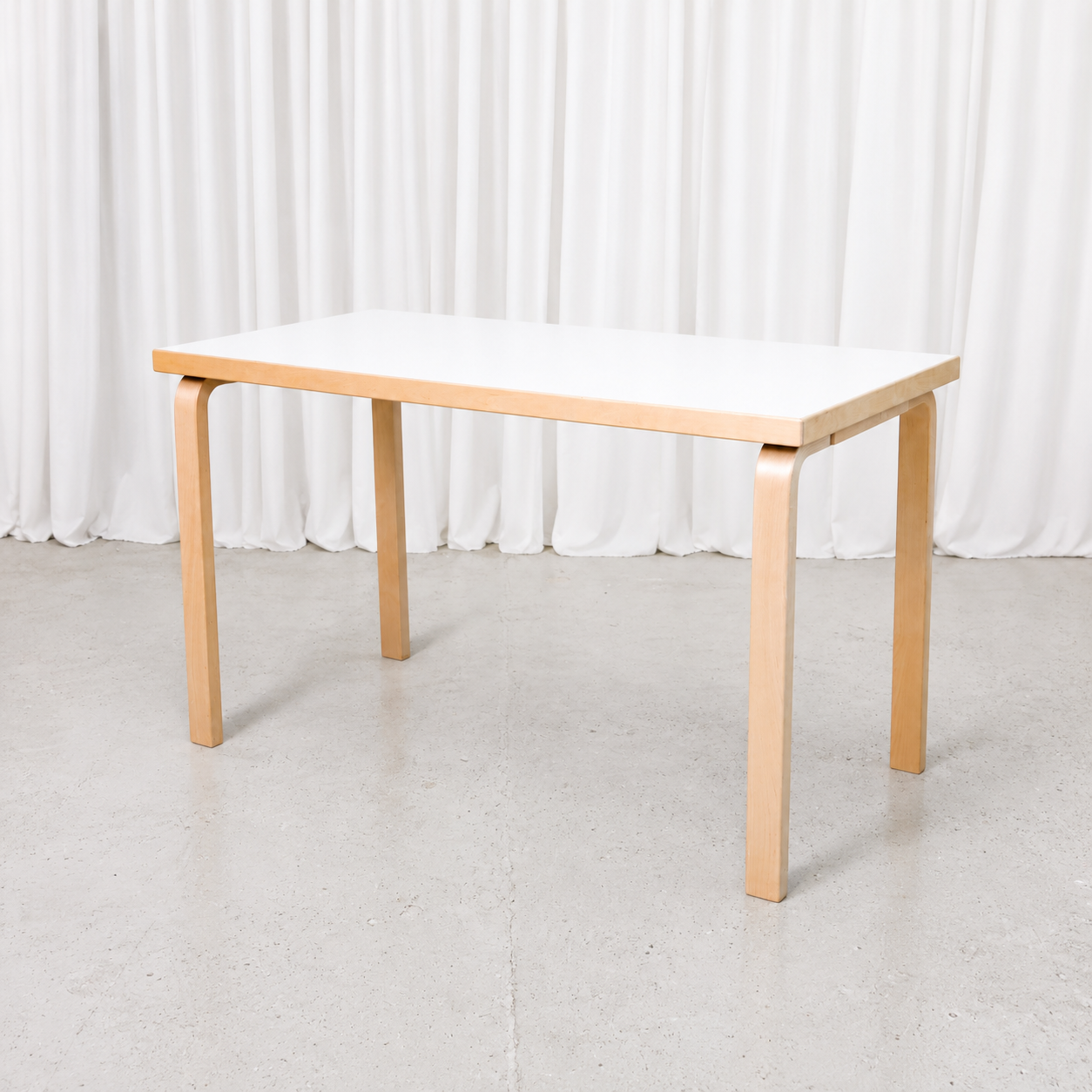 Classic Artek table by Alvar Aalto with a white laminate top and natural birch legs. Good used condition. Dimensions 120 × 60 × 71 cm.