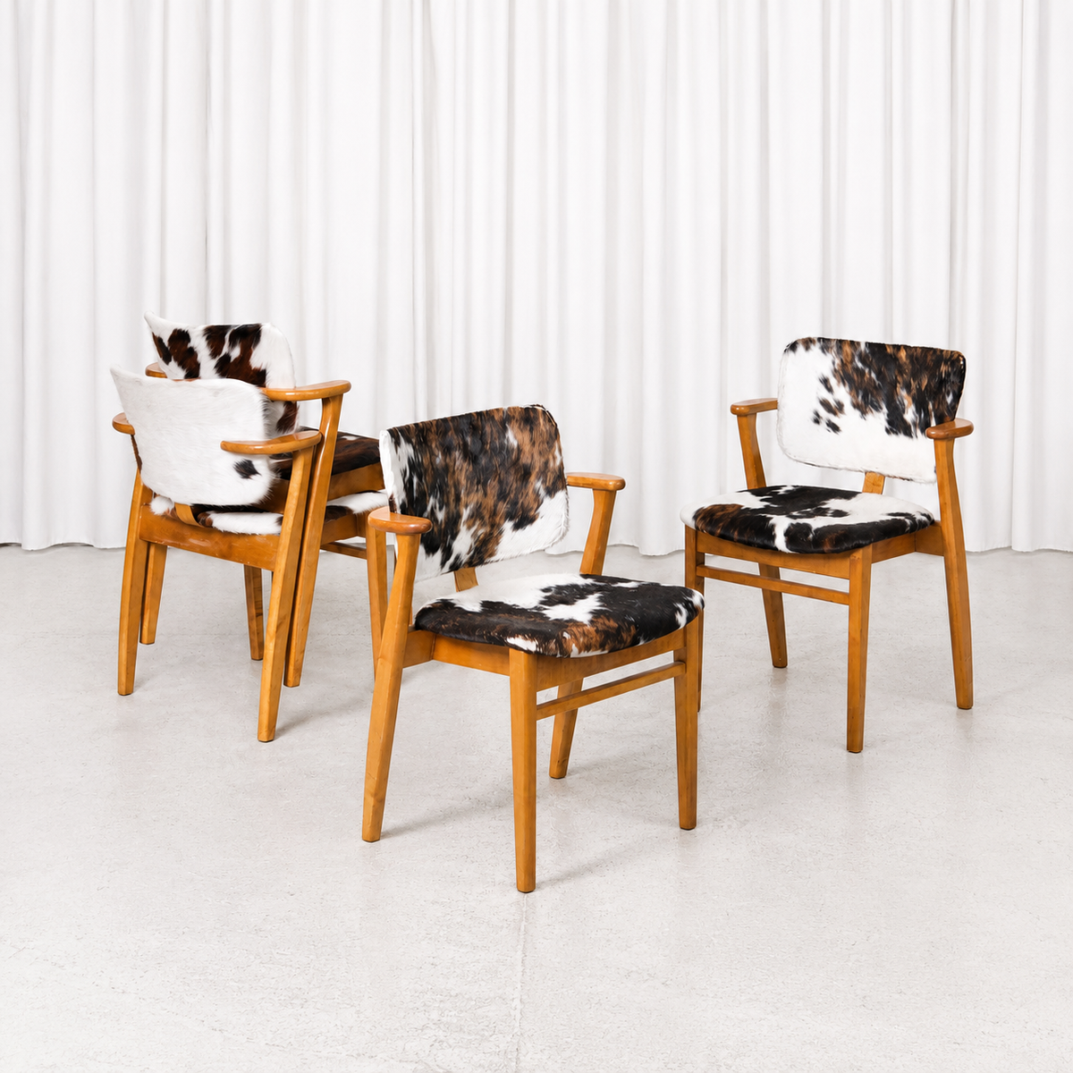 Domus Chairs with Cowhide by Ilmari Tapiovaara. warm wooden frames and beautiful age-related patina.