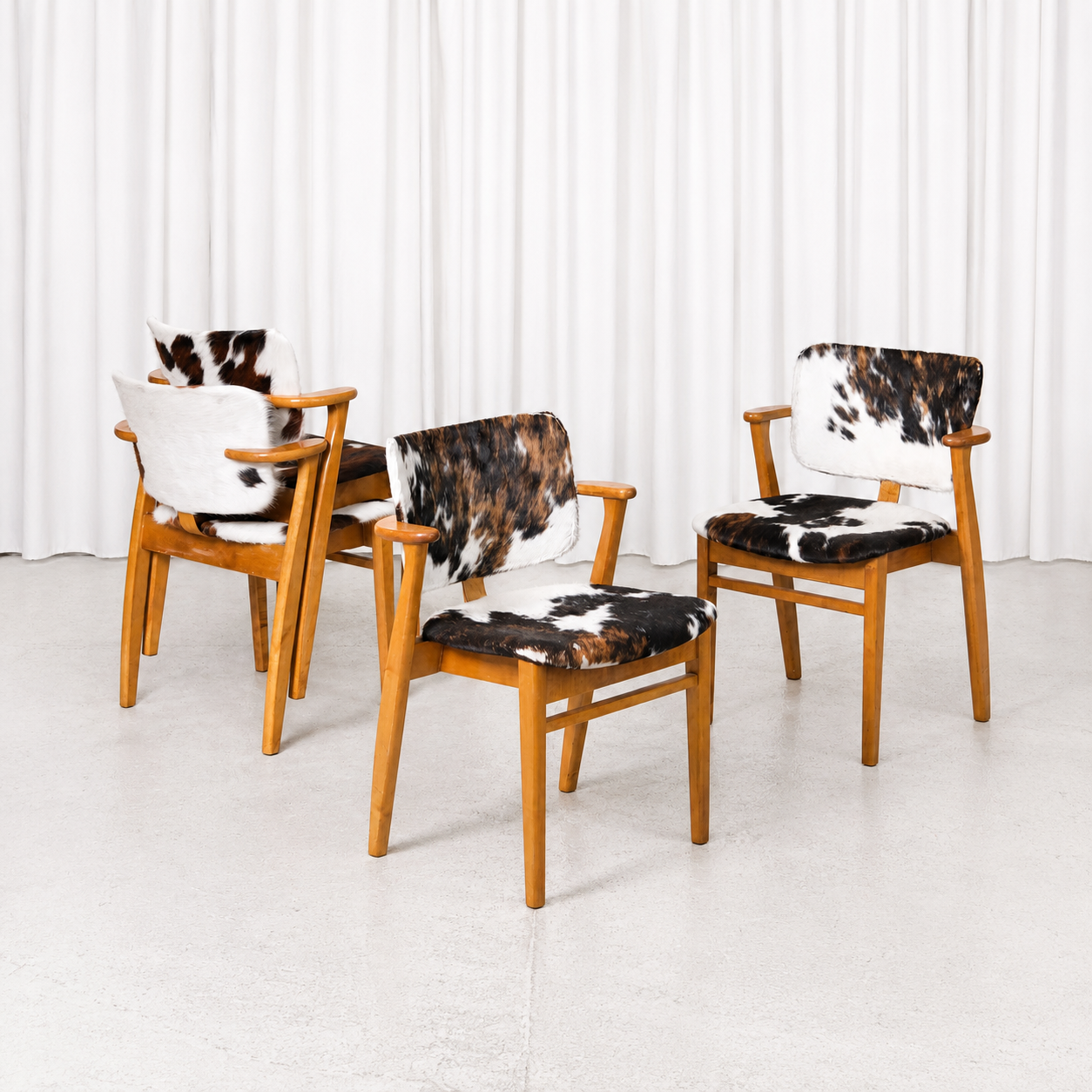 Domus Chairs with Cowhide by Ilmari Tapiovaara. warm wooden frames and beautiful age-related patina.