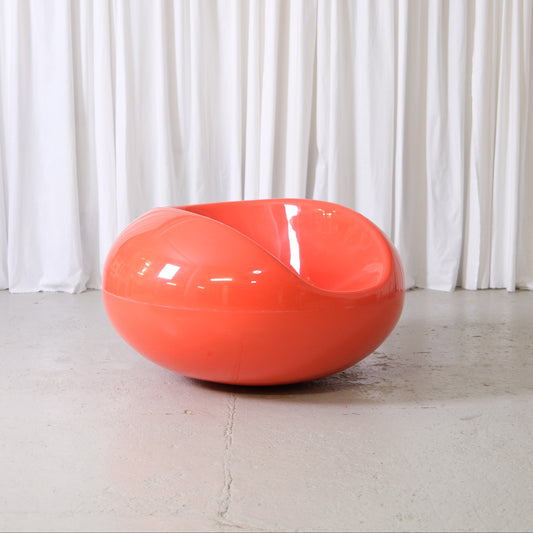 Eero Aarnio Pastilli chair in orange glossy fiberglass, Finnish Space Age design lounge chair photographed at Pino Interiors Helsinki.