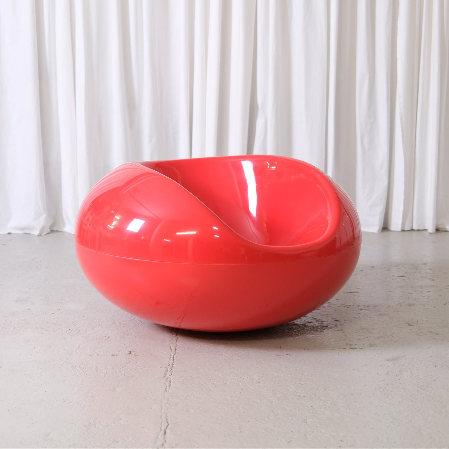 Eero Aarnio Pastilli chair in red glossy fiberglass, Finnish Space Age design lounge chair photographed at Pino Interiors Helsinki.