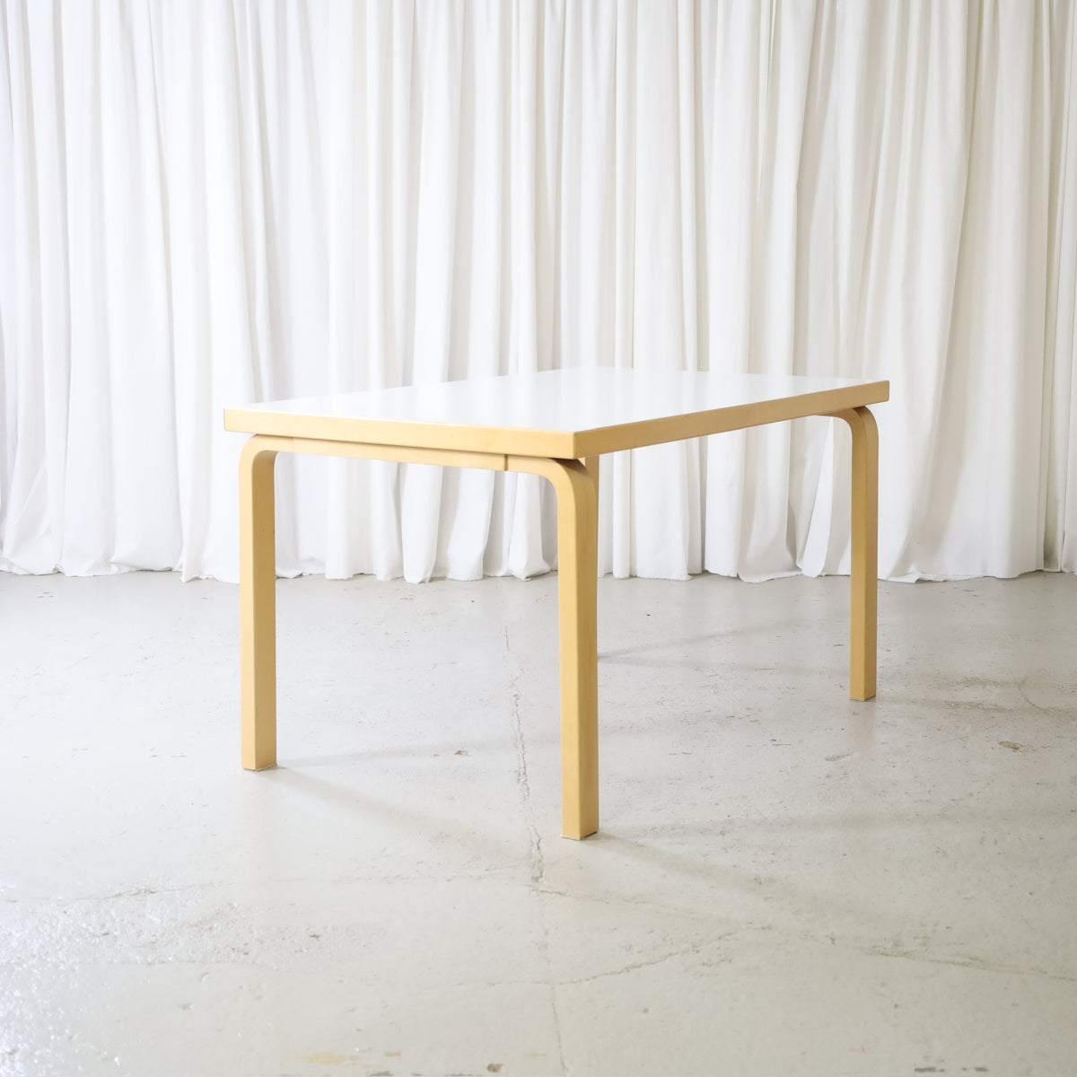 Alvar Aalto dining table by Artek, front angled view