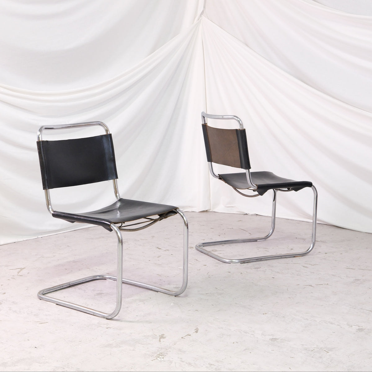 Vintage Mart Stam cantilever chairs in chrome tubular steel with black leather seat and backrest