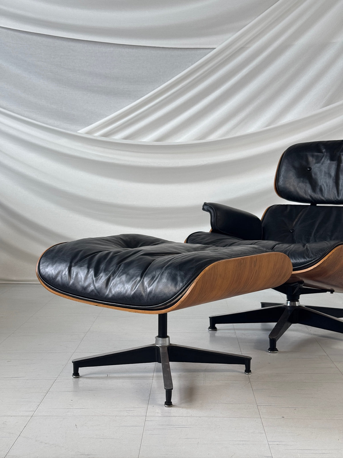 Herman Miller Eames Lounge Chair -lepotuoli ja rahi, ruusupuu ja musta nahka, Yhdysvallat, 1960-luku
