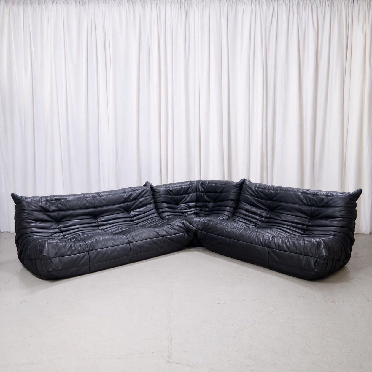 Ligne Roset Togo modular sofa set in black leather with three-seater, two-seater and corner piece
