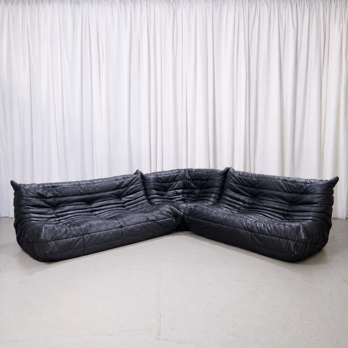 Ligne Roset Togo modular sofa set in black leather with three-seater, two-seater and corner piece
