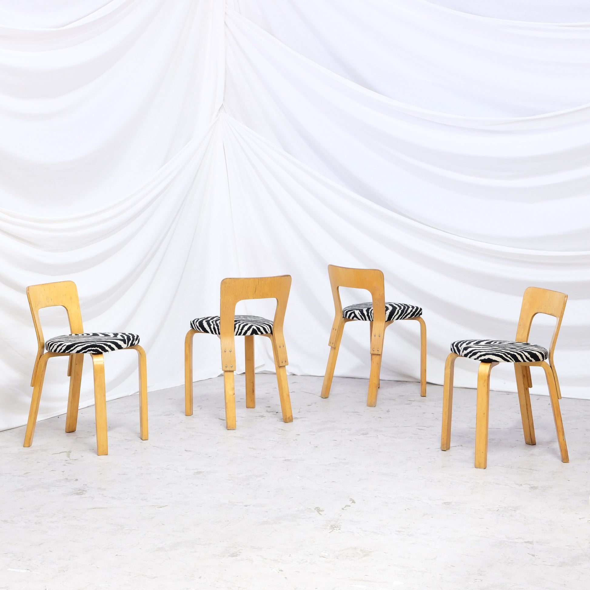 Rare vintage Artek A65 chairs from the 1940s to 1950s with beautiful patina and zebra upholstery. A hard-to-find Finnish design set.