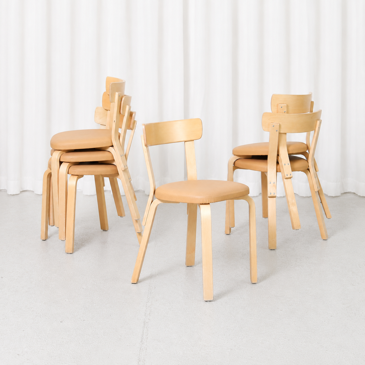 Vintage Artek Chair 69 designed by Alvar Aalto, featuring a birch frame and beige upholstered seat. Good vintage condition with minor wear.