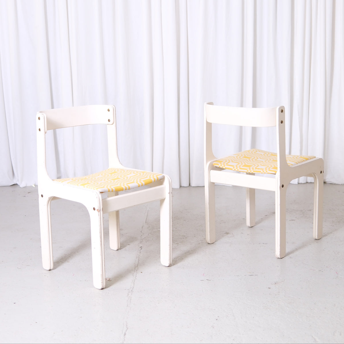 Vintage Kristian Gullichsen chair with white painted frame and newly upholstered yellow patterned seat in yellow fabric