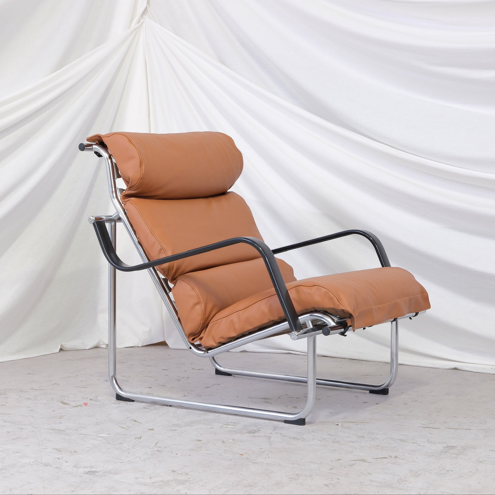 Vintage Yrjö Kukkapuro Remmi lounge chair with new brown leather upholstery and metal frame. Finnish design classic with worldwide shipping.