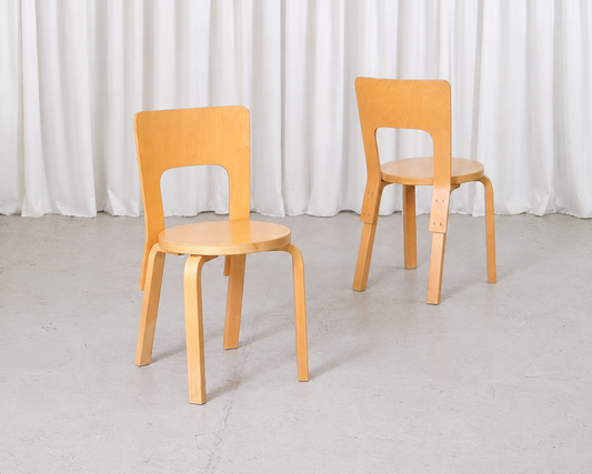 Pair of vintage Artek Chair 66 chairs by Alvar Aalto in natural birch, angled view