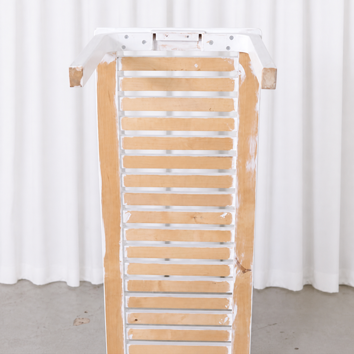 Underside of Artek 153A bench showing birch construction and later white paint