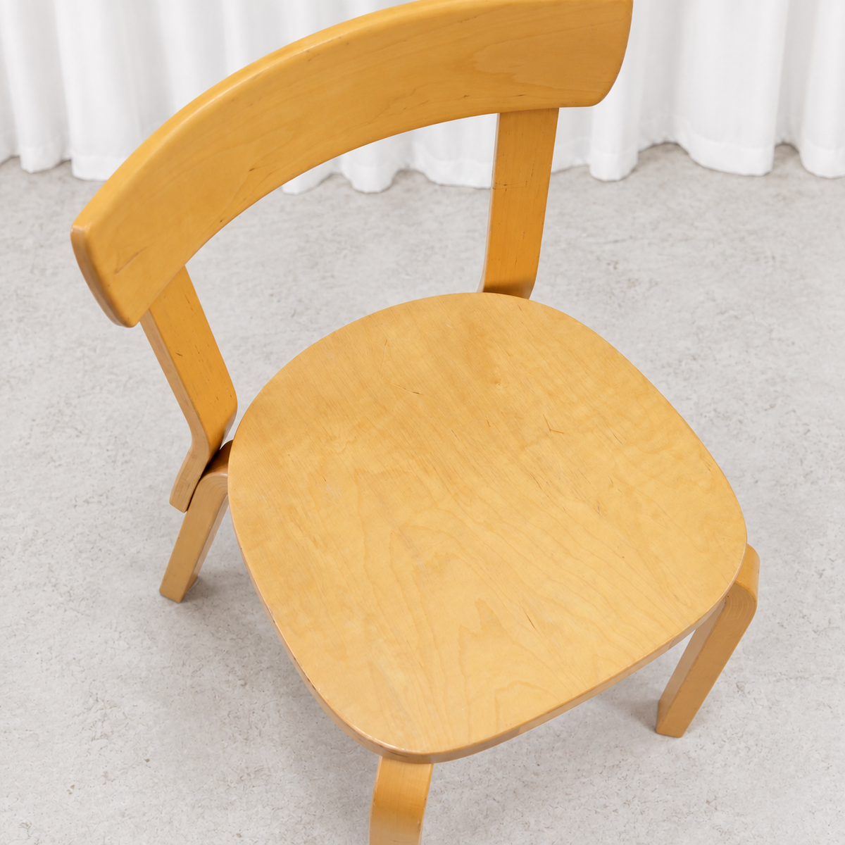 Vintage Artek Chair 69 in birch showing light wear and patina on the seat