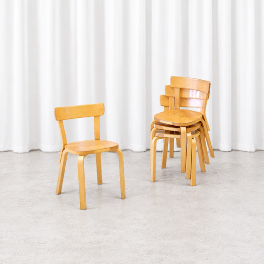 Four vintage Artek Chair 69 chairs in birch, with one chair beside a stacked group