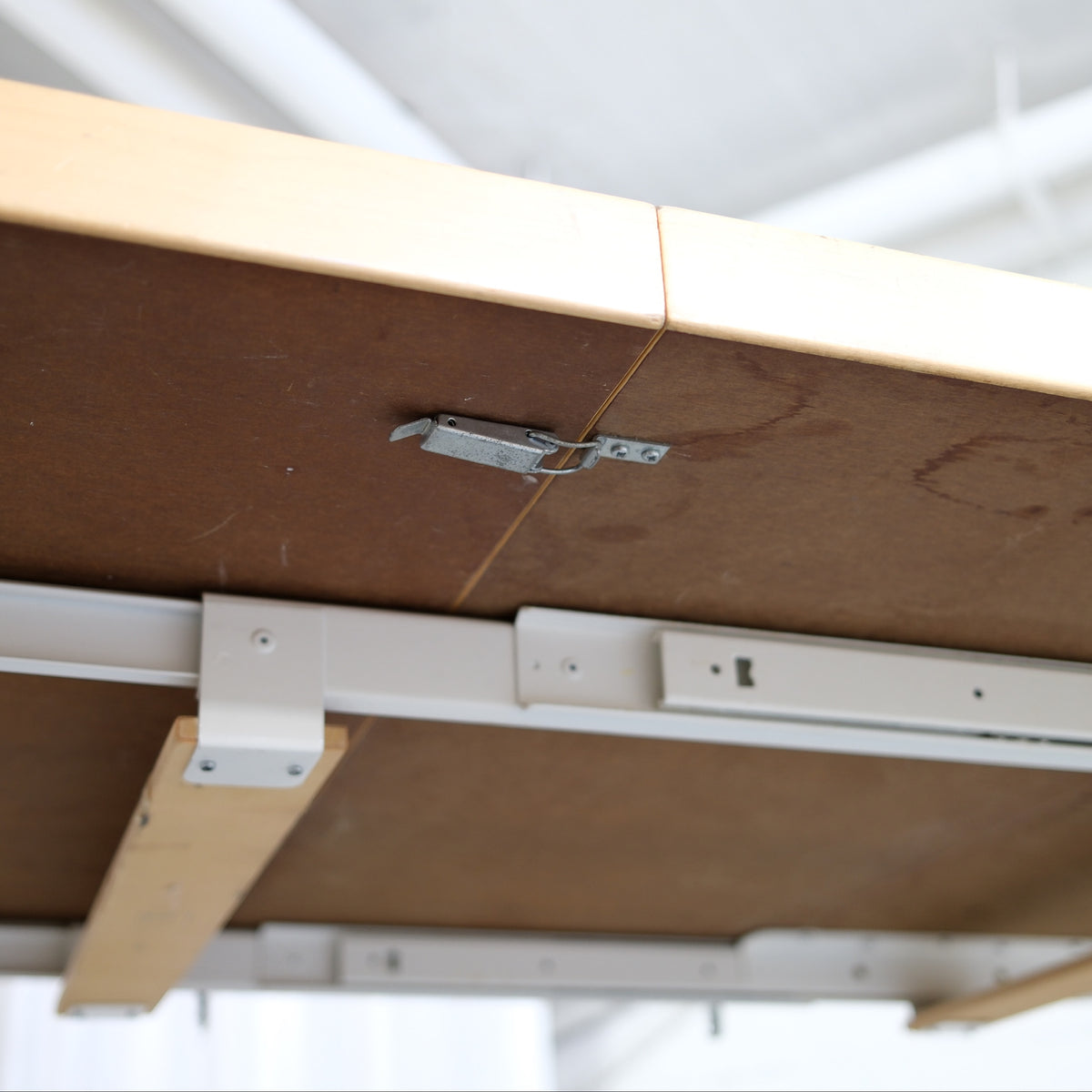 Underside of an Artek H99 table showing the extension mechanism