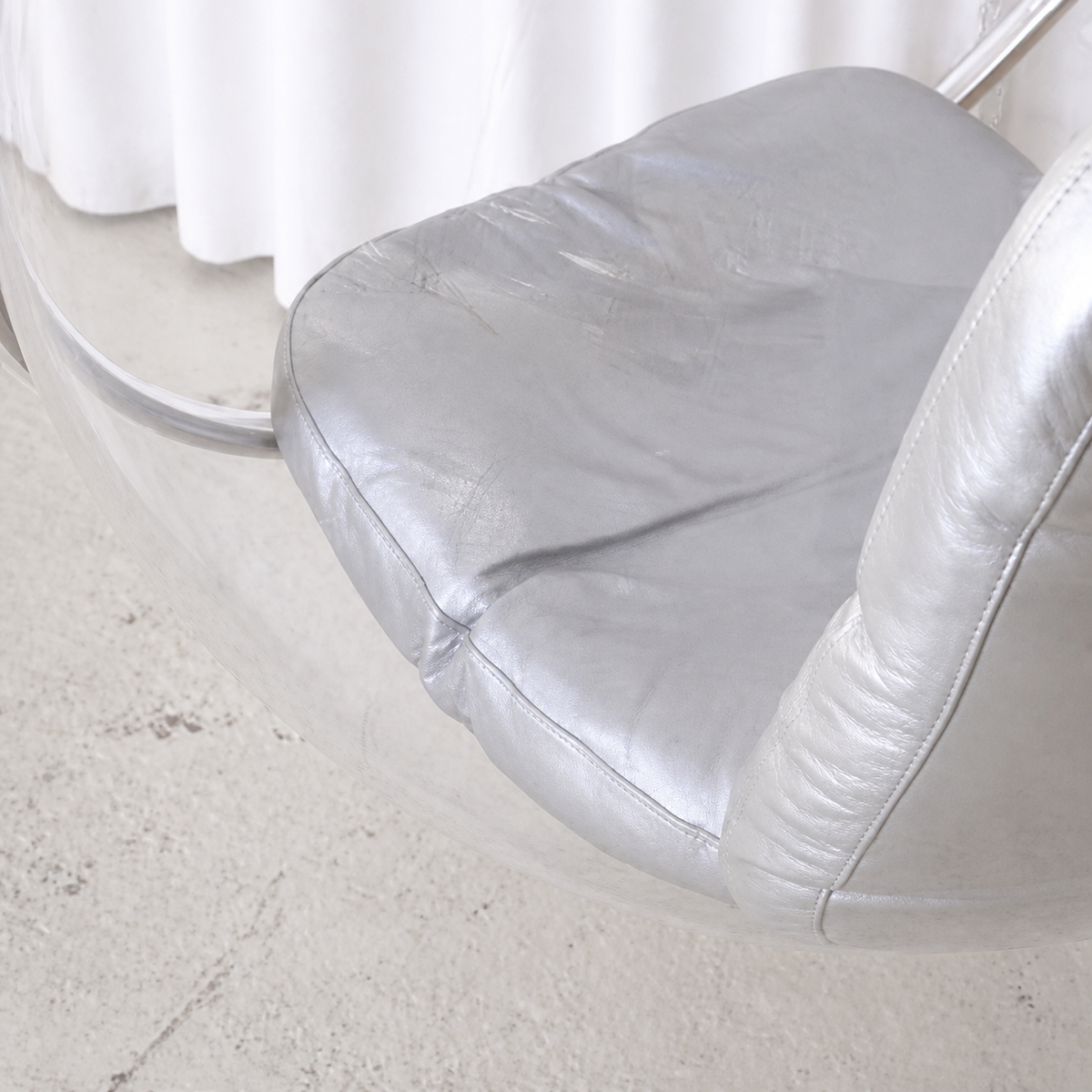 Silver leather seat cushion detail on Eero Aarnio Bubble Chair