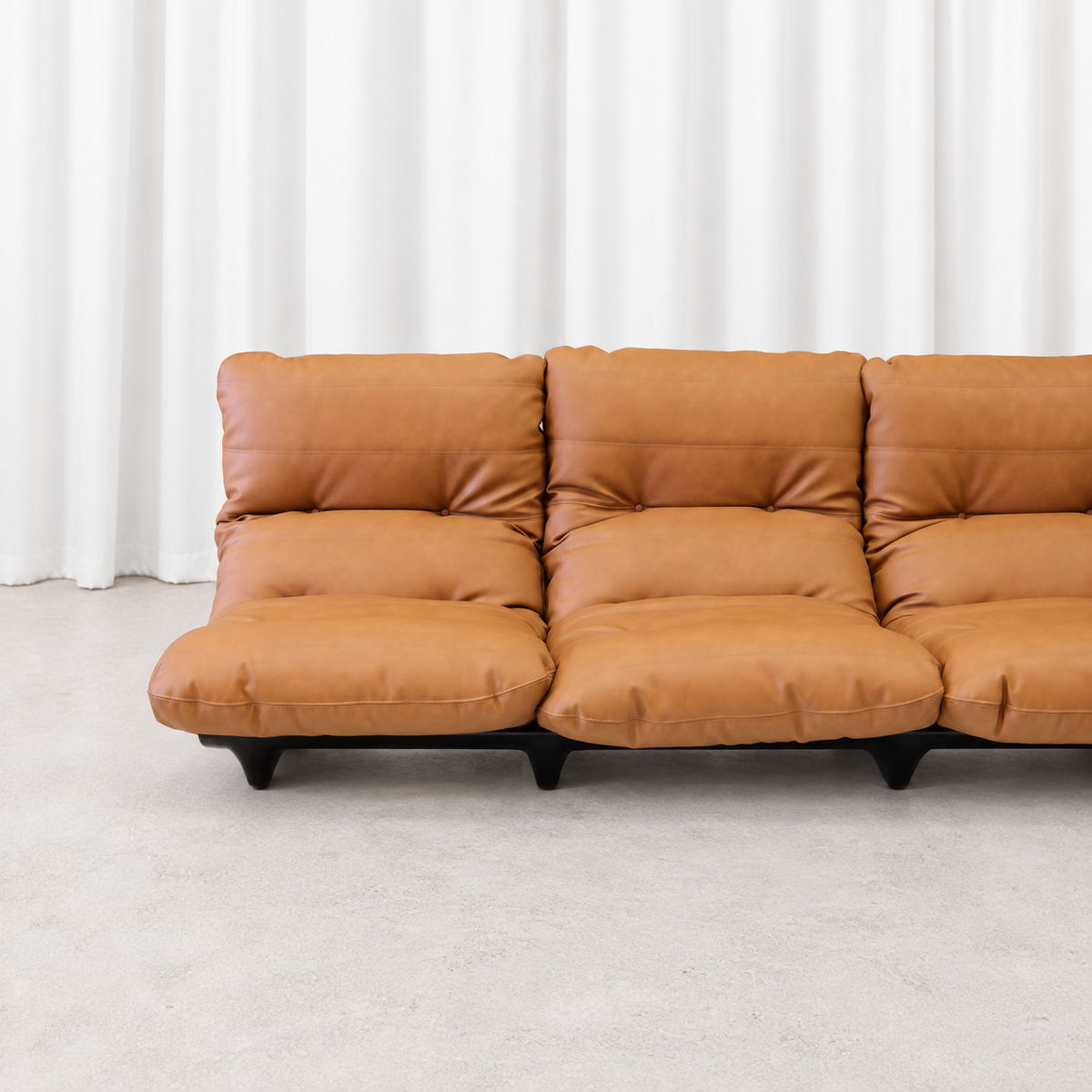 Ligne Roset Marsala sofa cognac leather cushions and stitching, close view.