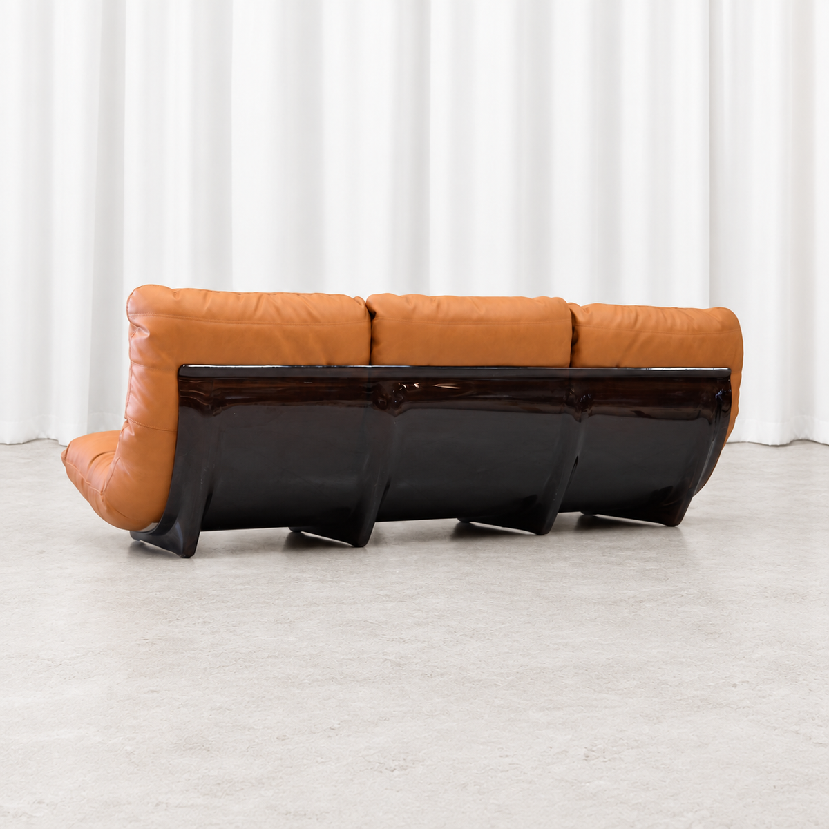 Ligne Roset Marsala three-seater sofa, rear left angle showing the smoked acrylic shell.