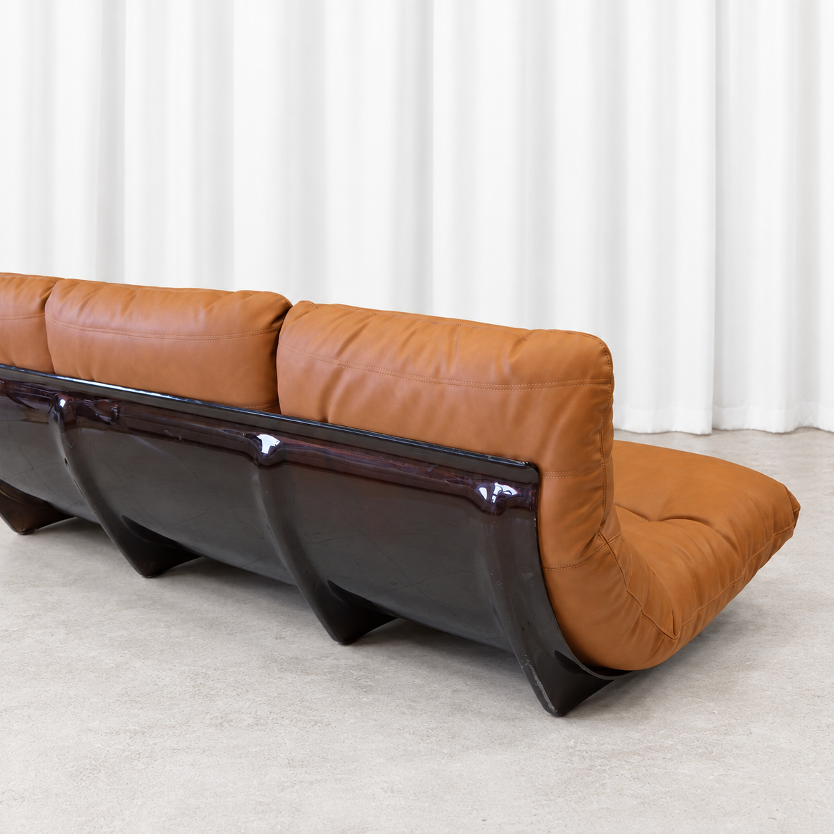 Ligne Roset Marsala three-seater sofa, rear right angle showing the smoked acrylic shell.