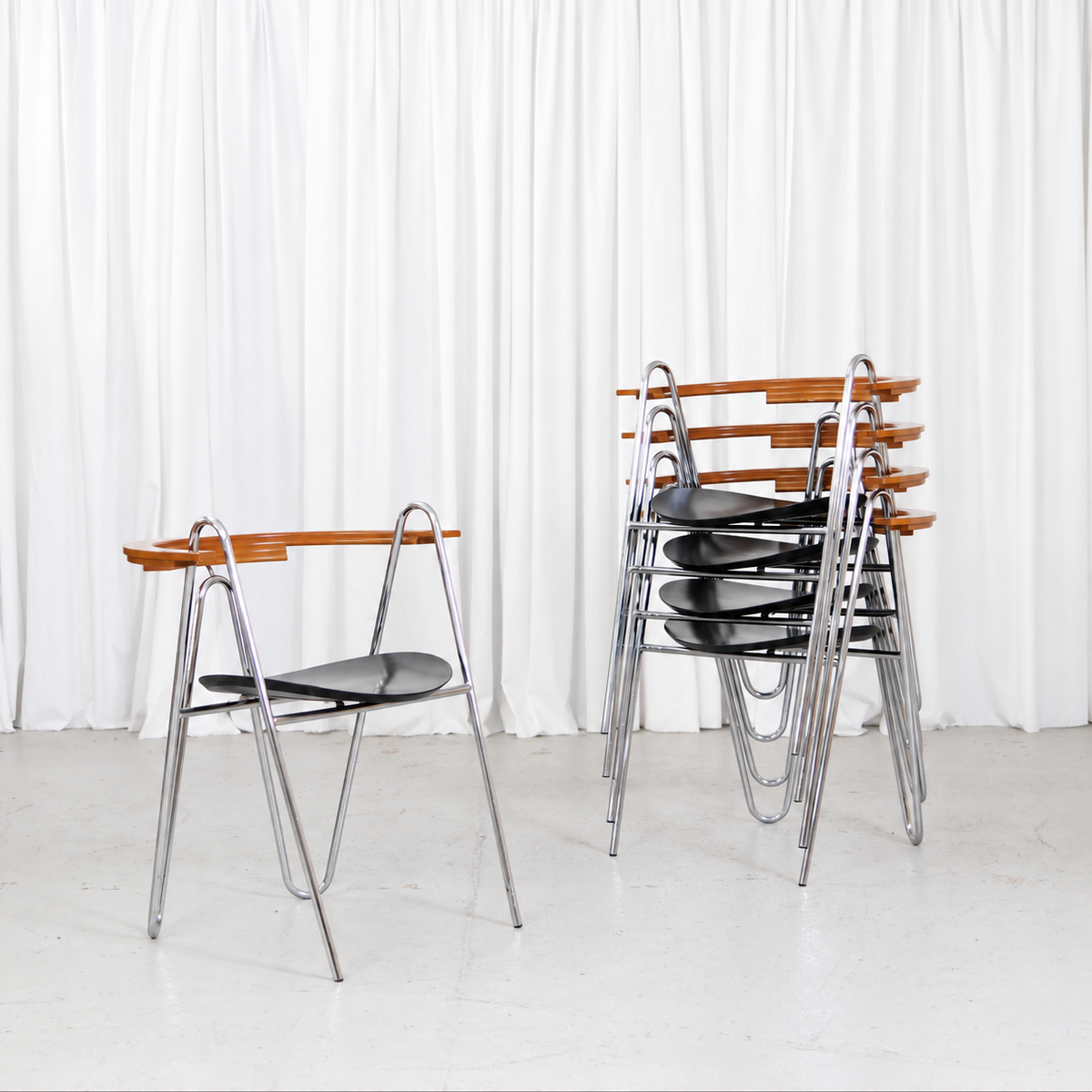 Five Pentti Hakala W chairs in chrome, black and wood, shown stacked and individually
