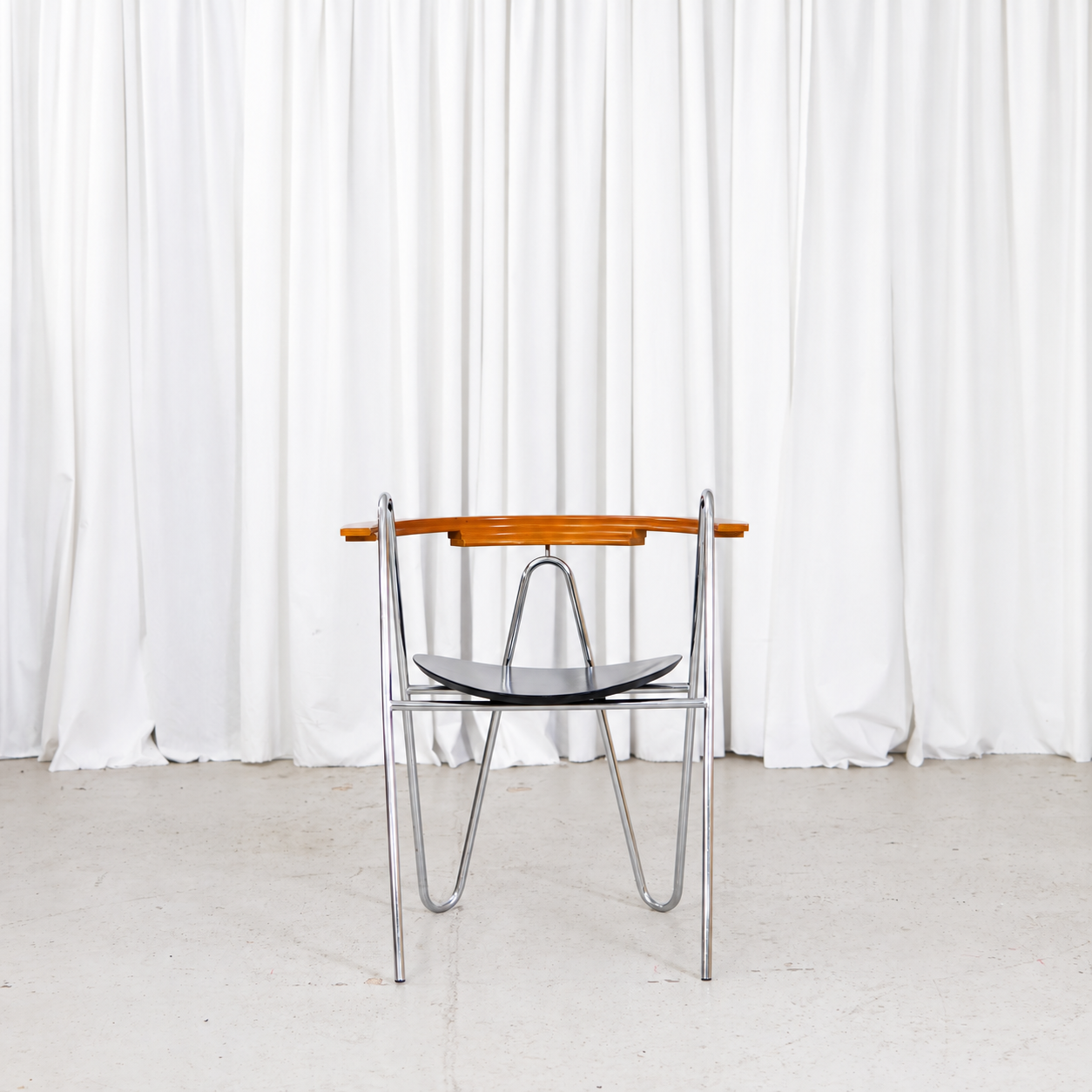 Front view of Pentti Hakala W chair in chrome, black and wood