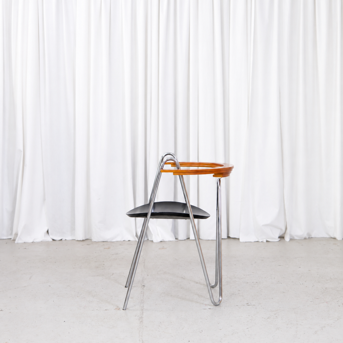 Side view of Pentti Hakala W chair with looped chromed frame