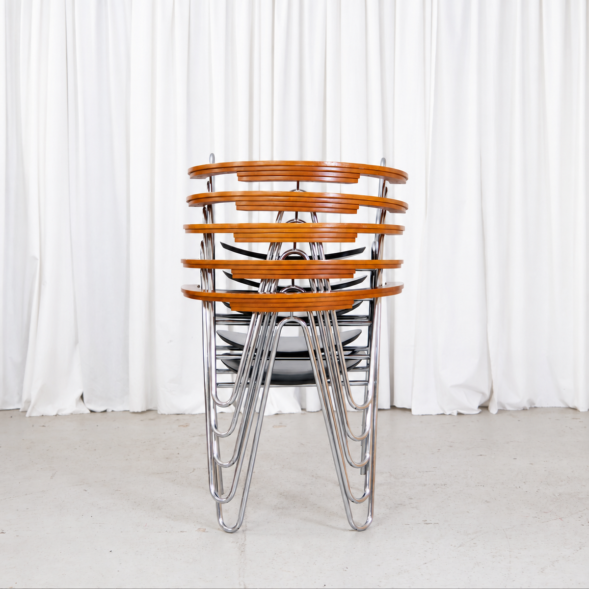 Rear view of five stacked Pentti Hakala W chairs