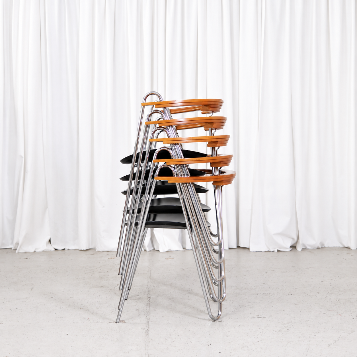 Side view of five stacked Pentti Hakala W chairs