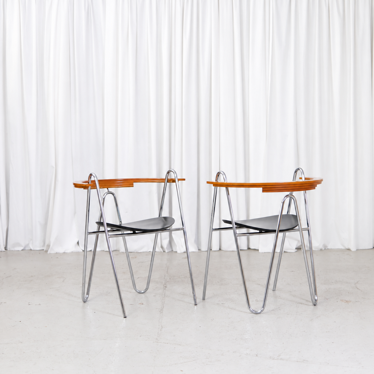 Pair of Pentti Hakala W chairs with chromed frames and black wooden seats