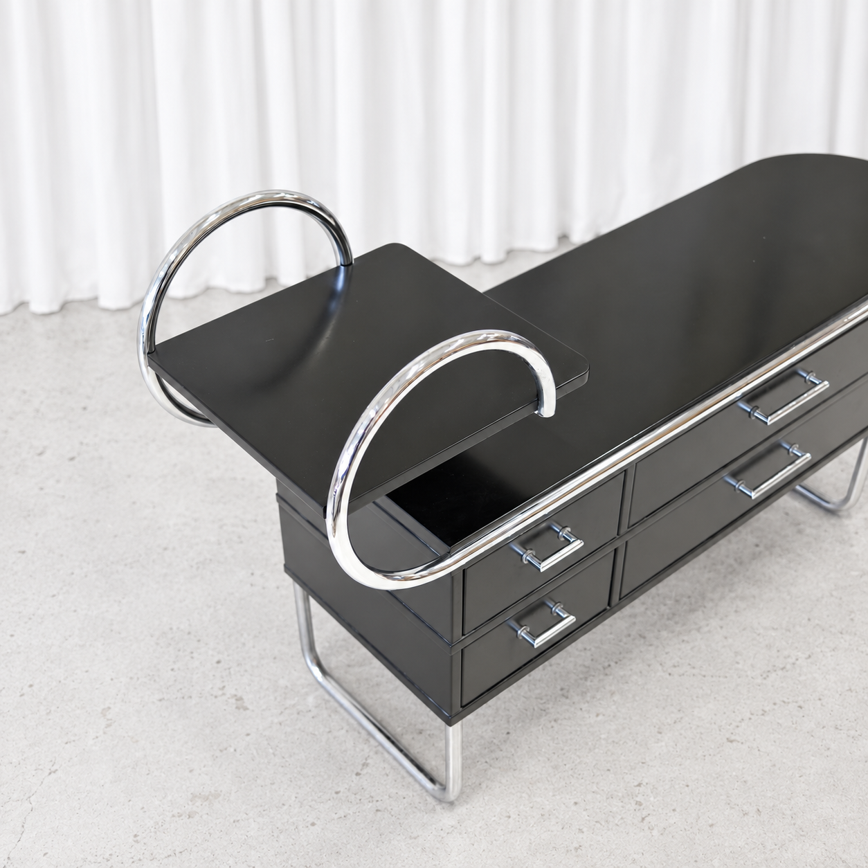 Post Deco 1300 credenza showing black top and chrome curves