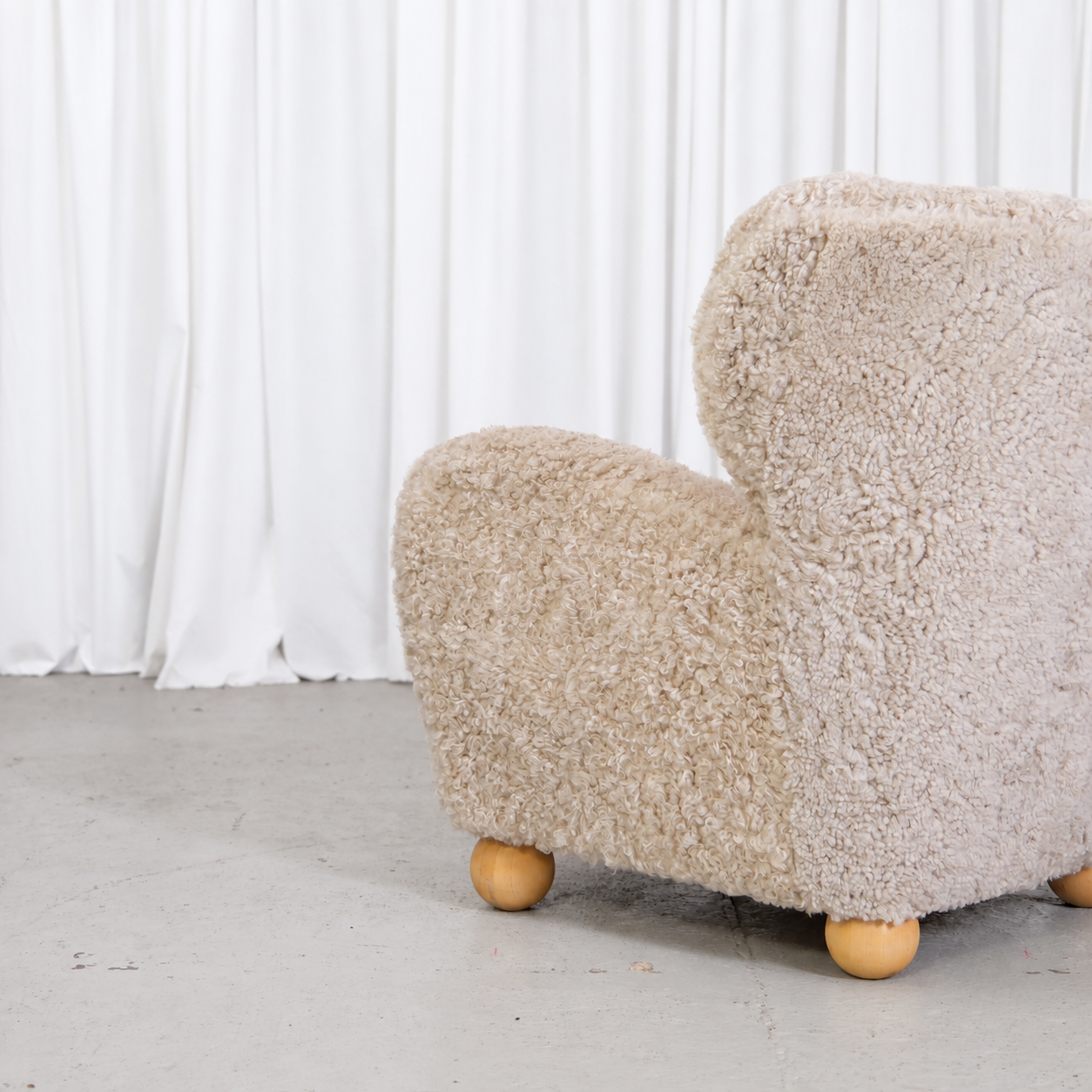 Vintage Danish sheepskin armchair, upholstery and leg detail